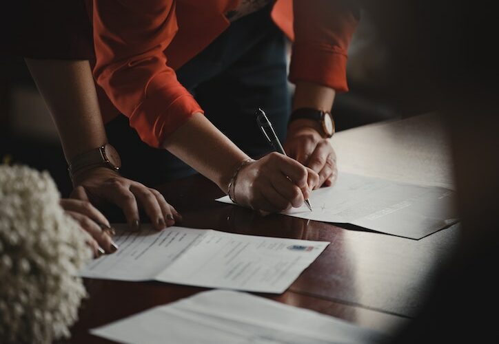 2 people signing paperwork